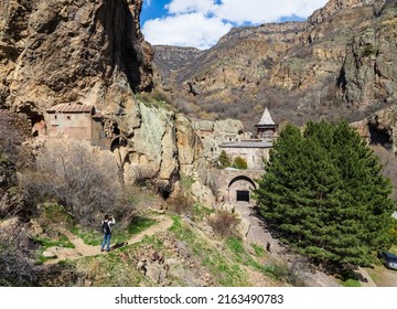 Geghard, Armenia - April 2022: A Tourist Taking Photos Of The Ruined Church In The Rocks And The UNESCO World Heritage Site Of Geghard Monastery, Located Southeast Of Geghard Village, Near Goght