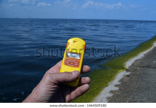 Geiger counter near storage pool near of\
hydroelectric station. After Chernobyl disaster - collection active\
sediments.The radiometer gives readings in micro-Sieverts. July 29,\
2019.Kiev ,Ukraine