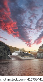 Geiranger Fjord With Cruise Against Sunset In Norway