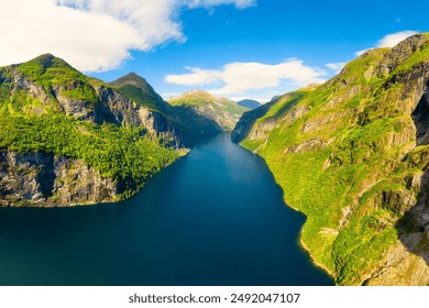 Geiranger Fjord, Norway. Nature in fjords. Traveling by boat on a Norwegian fjord. Scandinavia. View of nature from the drone. Seven Sisters Waterfall. Vacation and travel in summer Norway. - Powered by Shutterstock