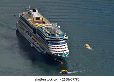 Geiranger, Norway - 07 July 2011: A Large Cruise Ship Full Of Tourists Sails On The Sea.