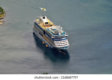 Geiranger, Norway - 07 July 2011: A Large Cruise Ship Full Of Tourists Sails On The Sea.