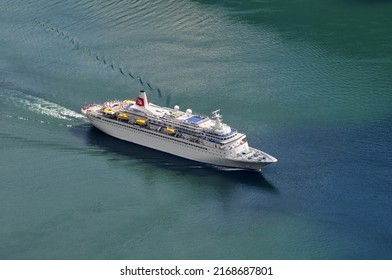 Geiranger, Norway - 07 July 2011: A Large Cruise Ship Full Of Tourists Sails On The Sea.