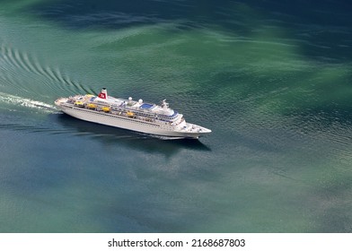 Geiranger, Norway - 07 July 2011: A Large Cruise Ship Full Of Tourists Sails On The Sea.