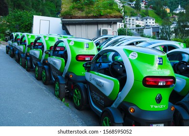 GEIRANGER, NORWAY - 15 JUN 2019: These small green electic cars are for rent by eMobility to tour the beautiful surrounding areas. Twizy is a tiny automobile model produced by Renault.