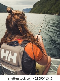 GEIRANGER, NORWAY - Aug 24, 2019: The Female Fisherman On A Boat In The Sea Hunting In Geiranger , Norway In Summer