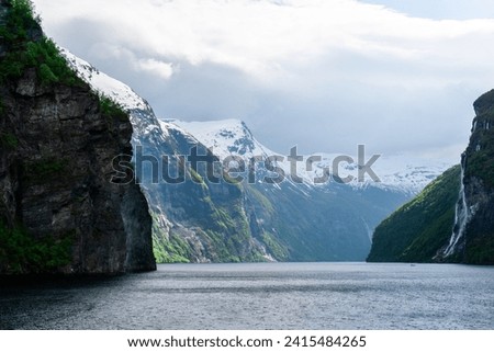 Geirangerfjord with waterfall at a cloudy day in norway