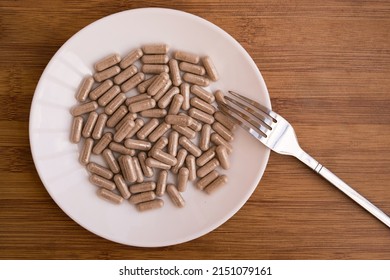 gel medical capsules, vitamins, dietary supplements lying on a plate. A pile of pills. Vitamins in capsules. Poured tablets with spoon and fork - Shutterstock ID 2151079161
