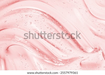 Gel texture. Clear pink liquid cosmetic background. Skincare serum, beauty cream with bubbles closeup