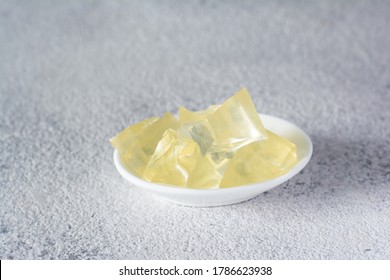 Gelatin, Agar-agar, Gelatinous Mass (cubes In The Form Of Crystals) On A Gray Background. Gelling Agent (collagen) For Culinary, Confectionery Products.