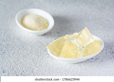 Gelatin, Agar-agar, Gelatinous Mass (cubes In The Form Of Crystals) On A Gray Background. Gelling Agent (collagen) For Culinary, Confectionery Products.