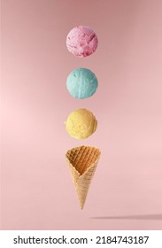 Gelato ice cream cone with colorful balls of ice cream falling. Abstract Infographic design of ice cream.Food deconstructed food styling concept.Trendy collage, creative art minimal aesthetic