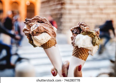 Gelato ice cream cone held up to the hot summer 