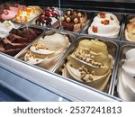 Gelato (Italian word for ice cream). Frozen treat or dessert with serval flavours from Italy. Made from whole milk, sugar, and other flavourings ex. fruit, chocolate, and nuts. 