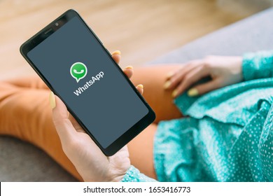 Gelendzhik, Russia, 19 November 2019: Unrecognizable Young Woman Using WhatsApp On Her Smartphone At Home. Point Of View In First Person.