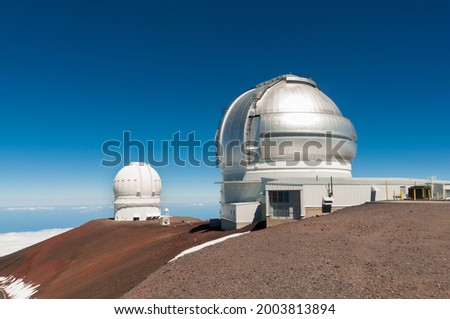 Gemini North Observatory on top of Mauna Kea mountain peak on Big Island of Hawaii, United States with deep blue sky and volcanic landscape