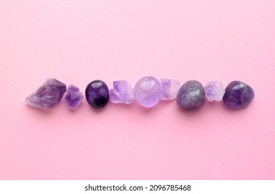 Gems Of Various Colors. Amethyst And Rose Quartz On Pink Background.