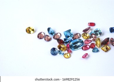 Gemstone facet cutting yellow sapphire variety shape on white paper background with selective focus