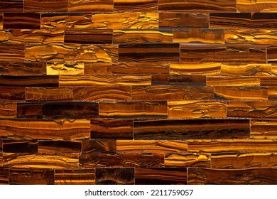 Gemstone Tiger Eye With Golden, Yellow Color Contrasted With Brown. Tiger Eye Texture As Nice Mineral Background. Quartz Beautiful Golden-brown Color With A Silky Sheen. Luxury Gemstone Background.