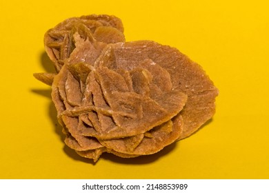 Gemstones Arranged On A Vibrant Yellow Construction Paper Background. 