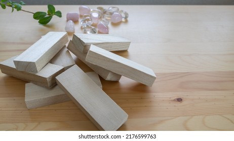 Gemstones and wooden blocks on the table. - Shutterstock ID 2176599763