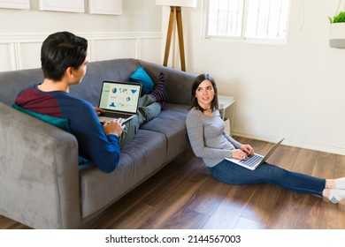 Gen z couple at home working remotely together. Young woman and man working from home as brokers on the finance business  - Shutterstock ID 2144567003