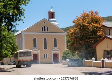 Genadendal, Overberg, Western Cape, South Africa. Dec 2019. Centre Of This Historic Town And Moravian Church Along The Garden Route. Old School Bus With Exhaust Smoke.