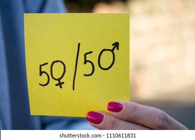 Gender Differences Concept, A Piece Of Paper With A Female And A Male Symbol In A Woman's Hand