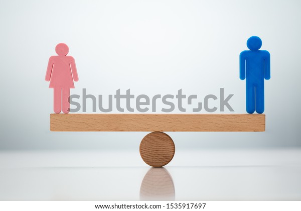Gender Equality Concept. Male And Female Balancing\
On Seesaw