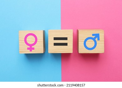 Gender Equality. Wooden Cubes With Equal, Male And Female Signs On Color Background, Flat Lay