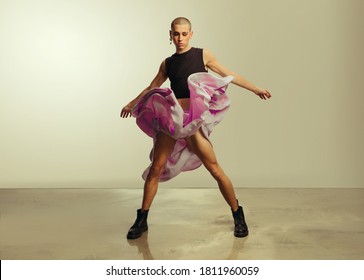 Gender Fluid Young Man In Crop Top And Skirt Dancing In Studio. Gay Man Dancing In Flowy Skirt