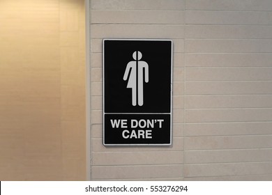 Gender neutral sign for the restroom that says, WE DON'T CARE