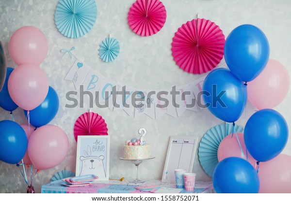 Gender party, blue and pink wall\
background, Boy or girl object in the wall and close up party table\
with cake and blue and pink plate, fork and\
napkins