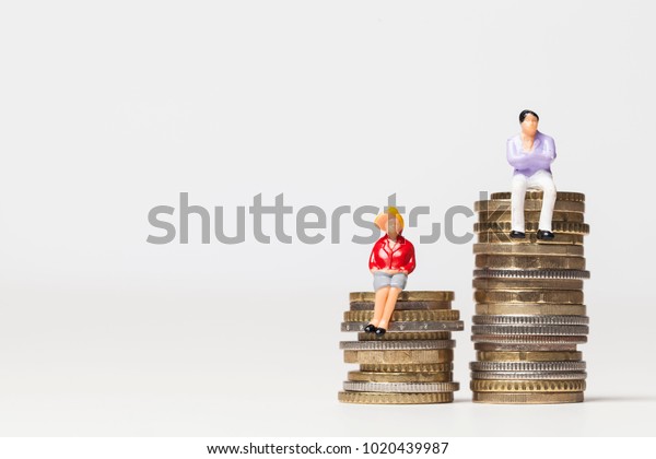 Gender pay equality concept. man and woman on a\
stack of coins.