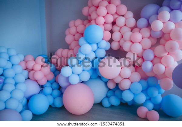 gender reveal\
party/ Blue and pink balloons for the holiday. the background.\
definition of a boy or\
girl