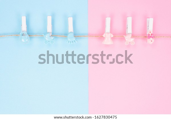 Gender reveal party\
invitation concept. Background photography of small pegs with\
carriage toys isolated on divided into two parts background with\
empty copy space