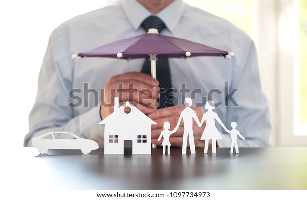 General agent protecting a family, a house and a\
car with his hands
