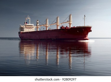 General Cargo Ship With Cranes Sailing In A Still Water. Dramatic Sky, Dark Clouds Before The Storm. Freight Transportation, Nautical Vessel, Global Communications, Industry, Carrying, Logistics