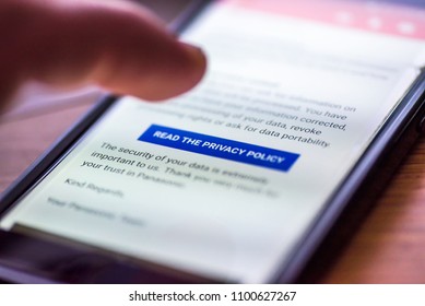 General Data Protection Regulation - GDPR - closeup human finger pointing to smartphone message button Read The Privacy Policy.