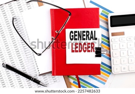 GENERAL LEDGER text on a notebook with chart, calculator and pen