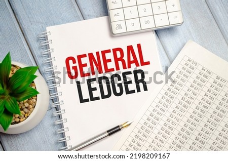 GENERAL LEDGER text written on white notebook with calculator and pen