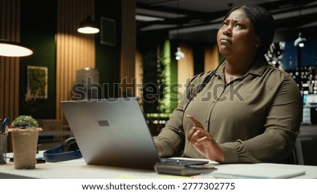 General manager engages in methodical planning after hours at corporate office, envisioning ideas and reflecting on business outlooks to turn challenging problem into tactical solution. Camera A.