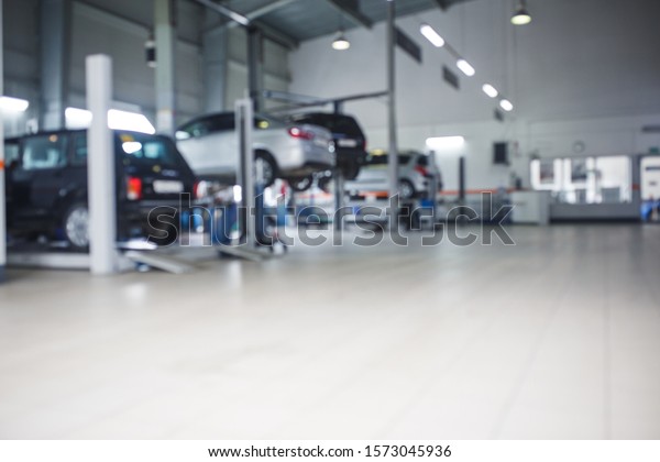 General plan of the car service station. The\
posts and lifts with the cars in blur, the background image of the\
service center.