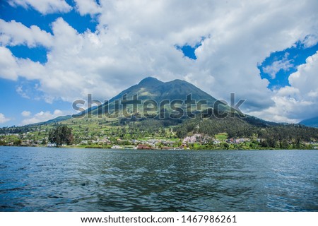 General plane of a landscape with a lake, a large mountain and a town called San Pablo, taken in Ecuador in the city of Otavalo on Lake San Pablo.