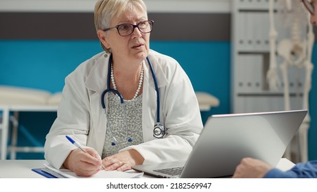 General Practitioner Taking Checkup Visit Notes On Documents, Creating Examination Report On Files To Give Prescription Medicine To Patient. Writing Health Care Information On Papers.