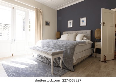 General view of bedroom interior with bed and big window. House interior and design concept. - Powered by Shutterstock
