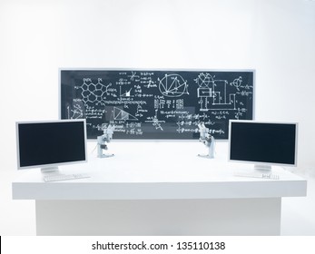 General- View Of A Chemistry Laboratory With A Lab Table, Two Microscopes And A Blackboard On The Background