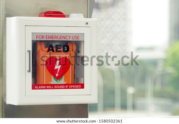 General view of a life saving defibrillator.\
Portable automated external defibrillator (AED) mounted on the wall\
in public restroom at\
airport.