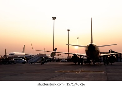 General View Of A Plane On The Tarmac In The Airport During Sunset