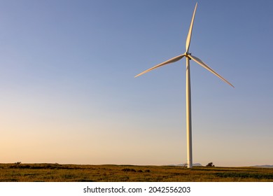 General view of wind turbine in countryside landscape with cloudless sky. environment, sustainability, ecology, renewable energy, global warming and climate change awareness. - Powered by Shutterstock
